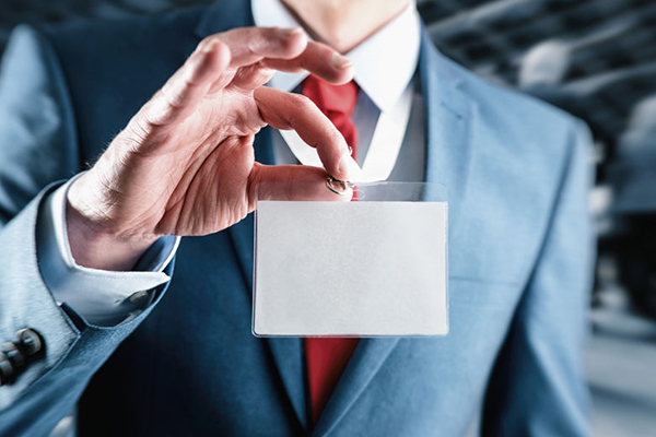 Businessman at an exhibition or tradeshow showing a blank securi