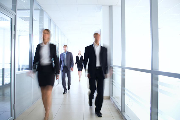 12508962 - business people walking in the office corridor